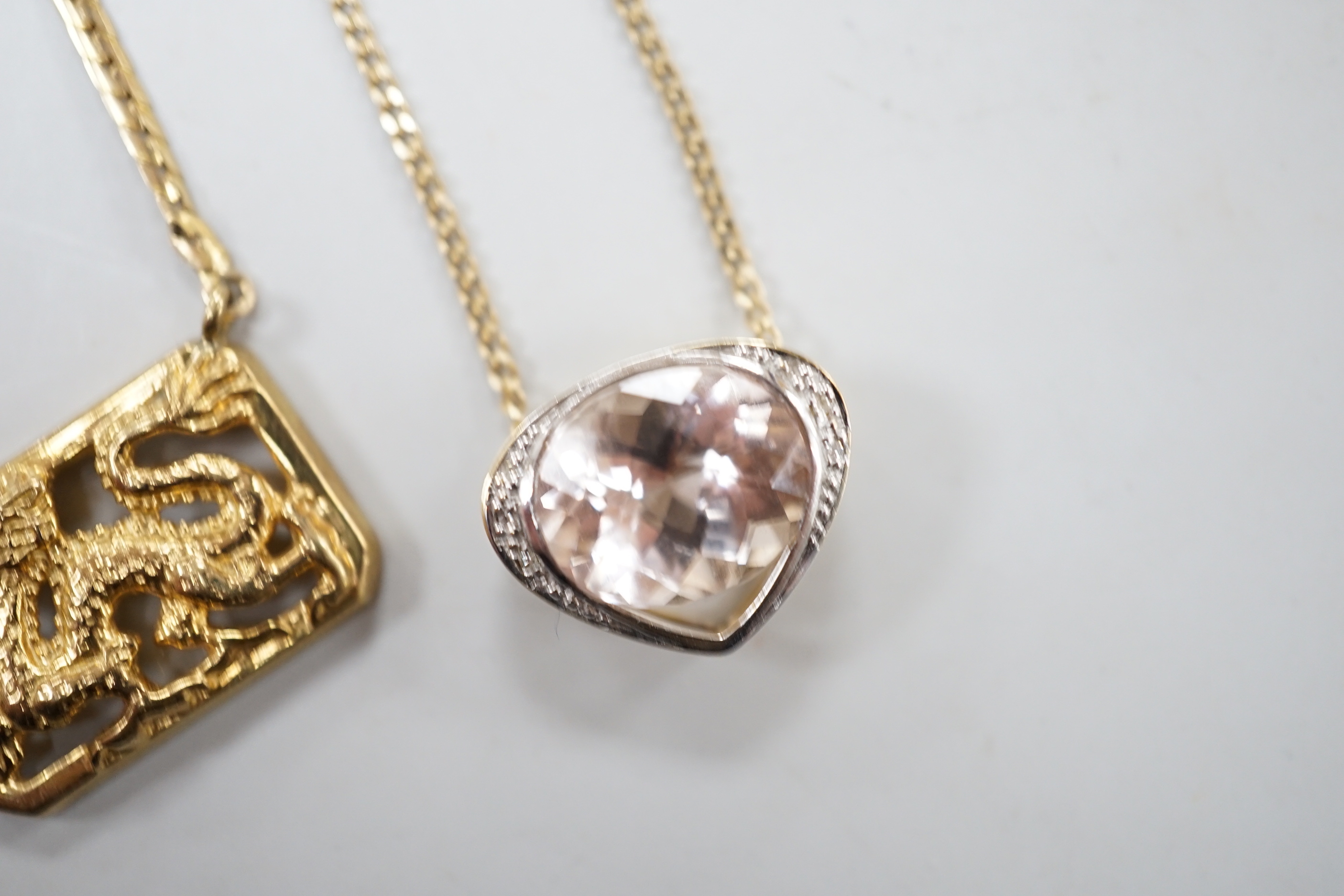 A modern 9ct gold and morganite? set heart shaped pendant necklace, 52cm and a 9ct gold Italian 'dragon' pendant necklace, gross weight 12.8 grams.